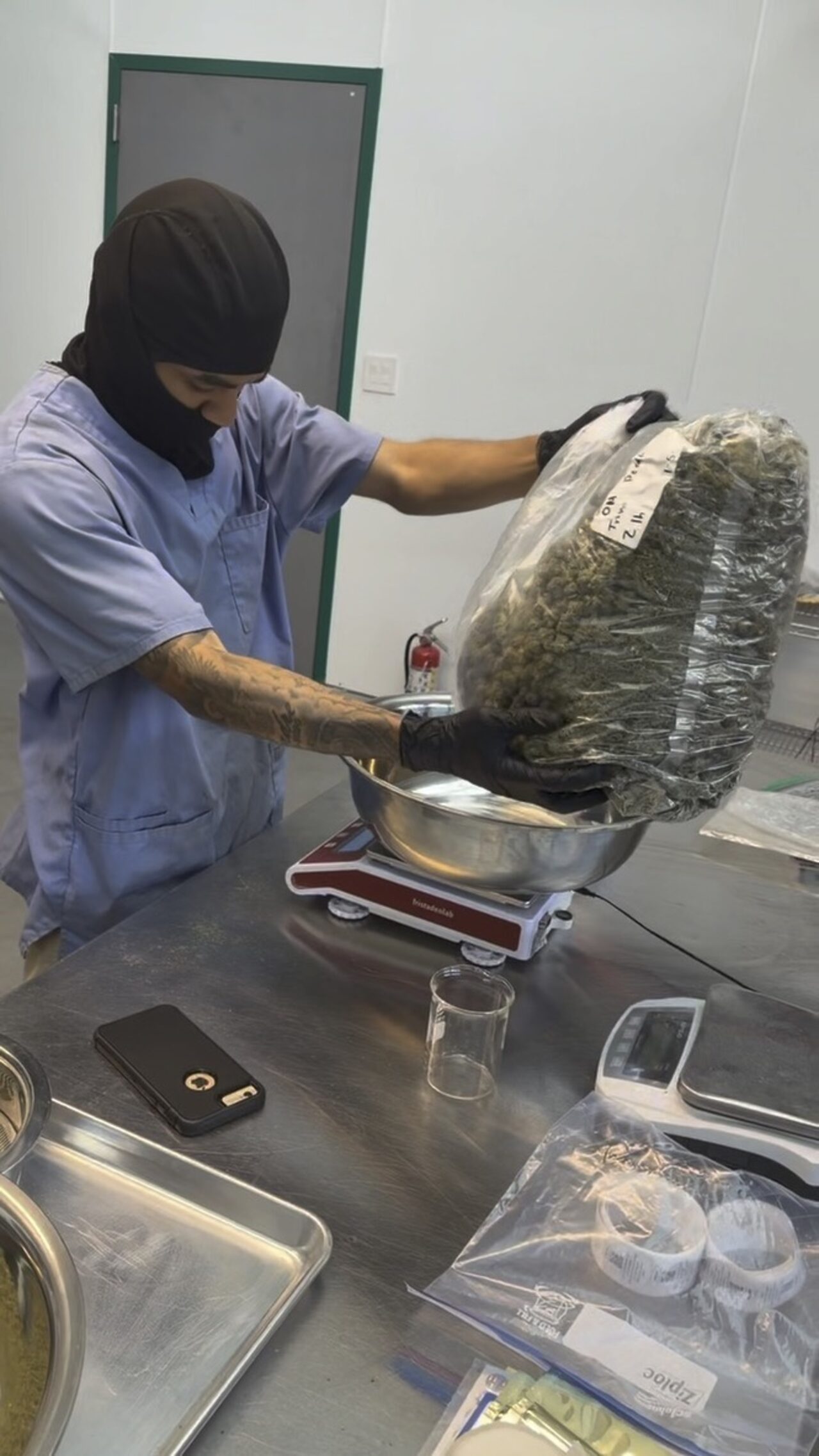 A team member handling product at a stainless-steel station